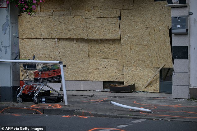 The boarded up windows of a food shop are seen, where a man rammed a van into it, in Essen, western Germany