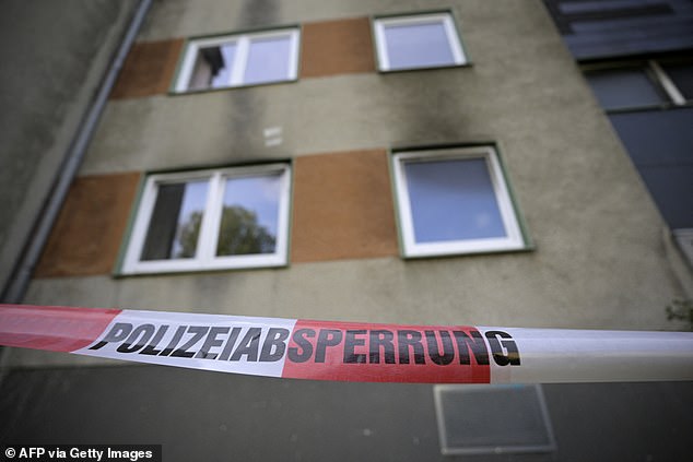 A police cordon is seen in front of an apartment building in Essen, which was set on fire