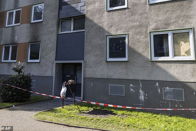 A cordon by the destroyed entrance door of an apartment building is pictured in Essen