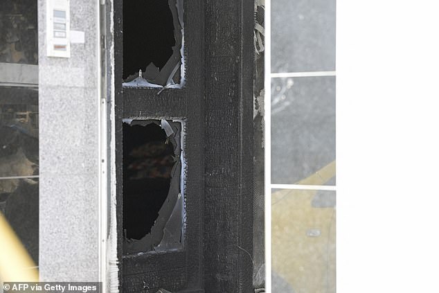 The damaged entrance door of a commercial and apartment building