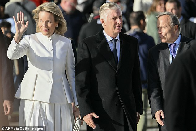 Also in attendance was Queen Mathilde's husband, King Philippe (right of the queen) of Belgium, who complemented his wife's all white ensemble by wearing an all black suit and tie