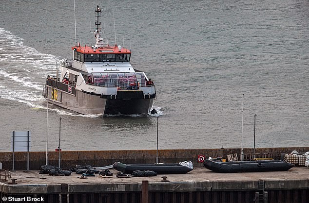 A Border Force vessel is seen bringing ashore in Kent migrants who had been attempying a small boat crossing of the Channel from France