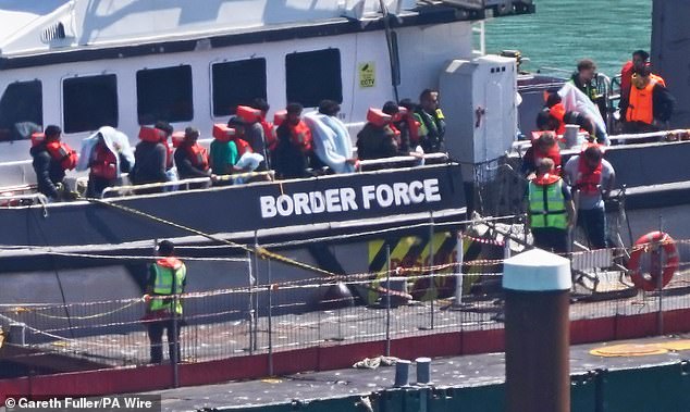 A group of people thought to be migrants are brought in to Dover, Kent, from a Border Force vessel following a small boat incident in the Channel on August 5 this year