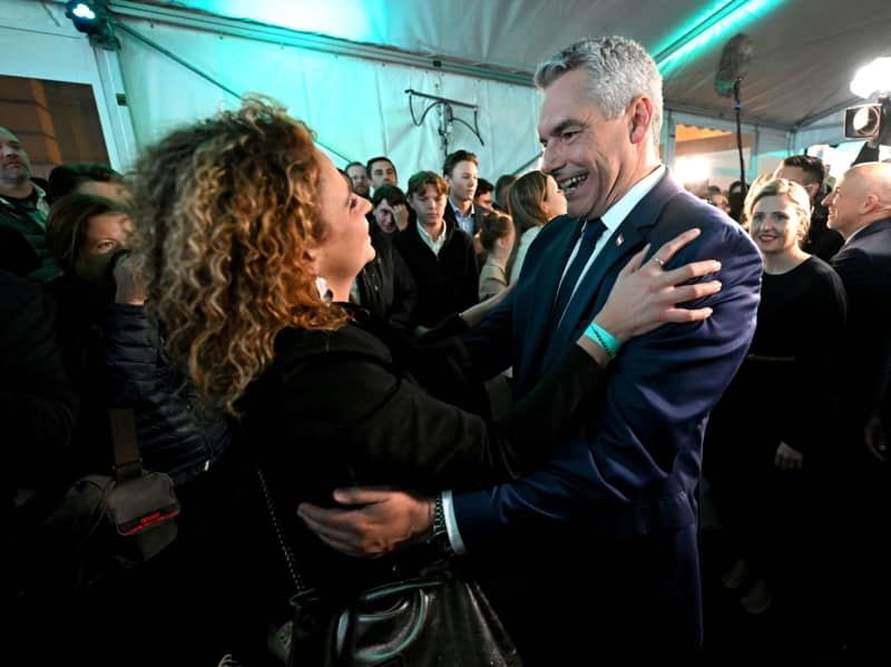 Austrian Chancellor Karl Nehammer of the Austrian People's Party (OeVP) cheers at the party headquarters after polls closed in the National Council election. Helmut Fohringer/APA/dpa