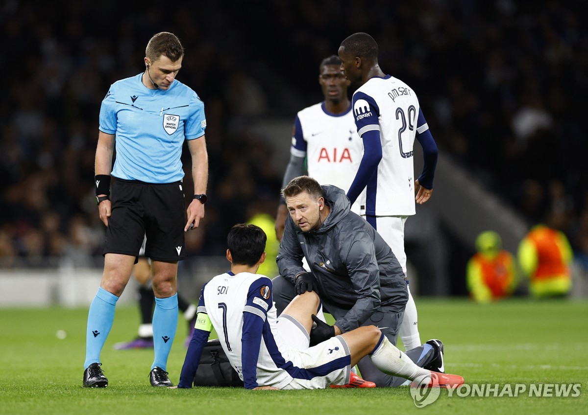 In this Action Images photo via Reuters, Son Heung-min of Tottenham Hotspur (C) receives medical attention after sustaining an injury during a UEFA Europa League match against Qarabag at Tottenham Hotspur Stadium in London on Sept. 26, 2024. (Yonhap)