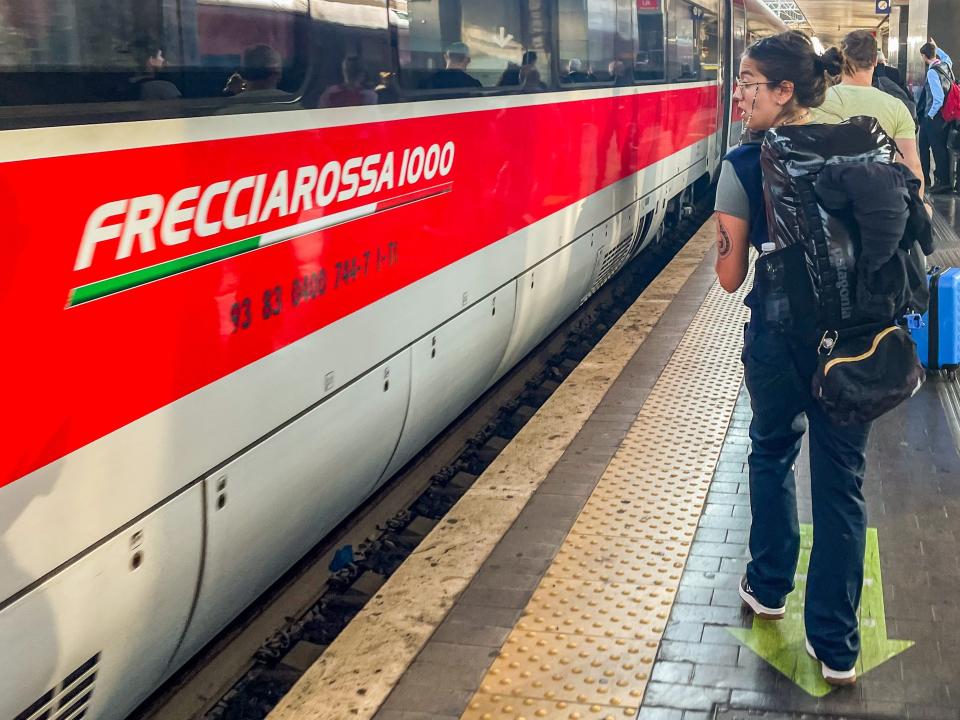 The author boards a train in Italy with her big backpack in October 2022.