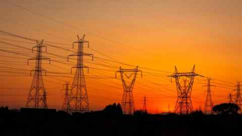 Summer sunset in Greece with electrical pylons near Thessaloniki city.