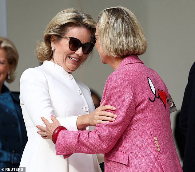 Queen Mathilde of Belgium (pictured left) was joined by Princess Delphine (right) today as the two attending Sunday mass directed by Pope Francis