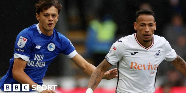 Perry Ng (left) of Cardiff City challenges Ronald of Swansea City