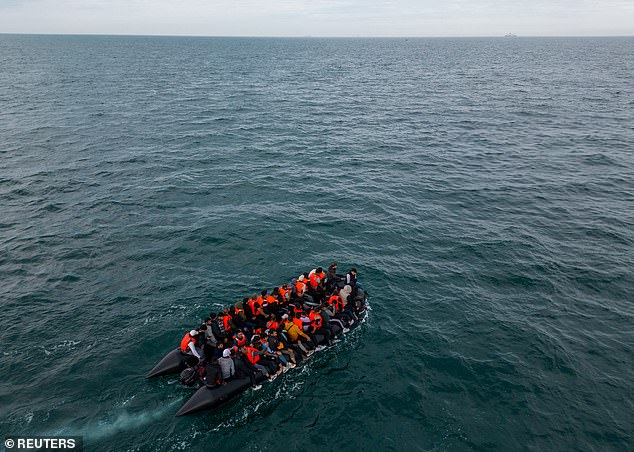 Picture shows an inflatable dinghy carrying migrants makes its way towards the English Channel on August 6, 2024