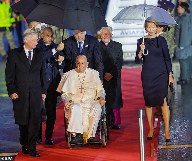 The King and Queen of Belgium braved the rain and rolled out the red carpet to welcome Pope Francis to their nation this evening