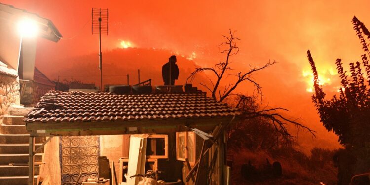 Wildfire burning through forest in southern Greece kills 2 people