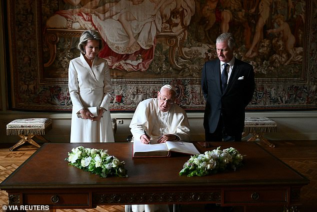 Pope Francis , 87, smiled amiably as he chatted to the Belgian royals and took the opportunity to signs the Book of Honour