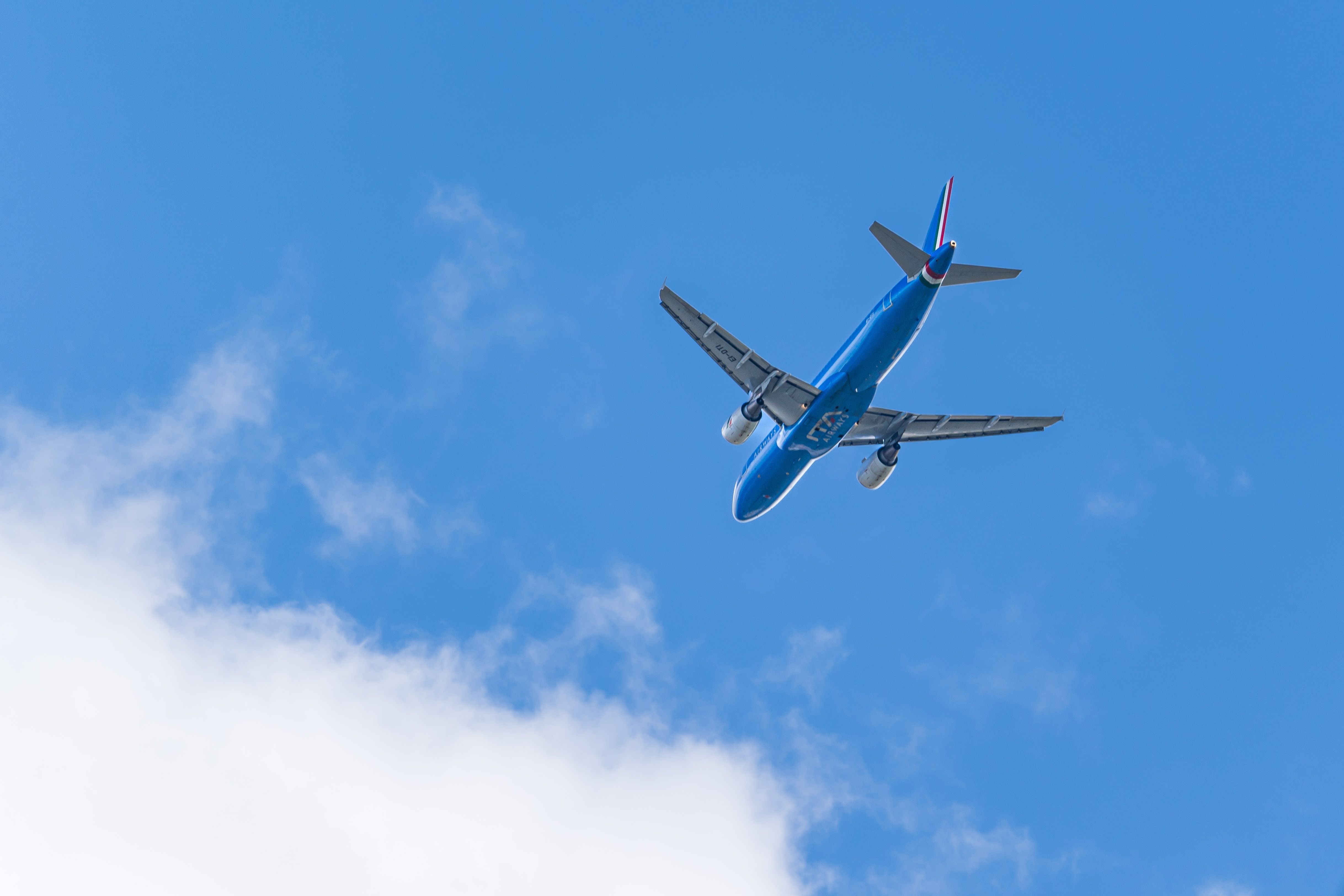 The ITA Airway Airbus A320 aircraft against a blue sky and white clouds