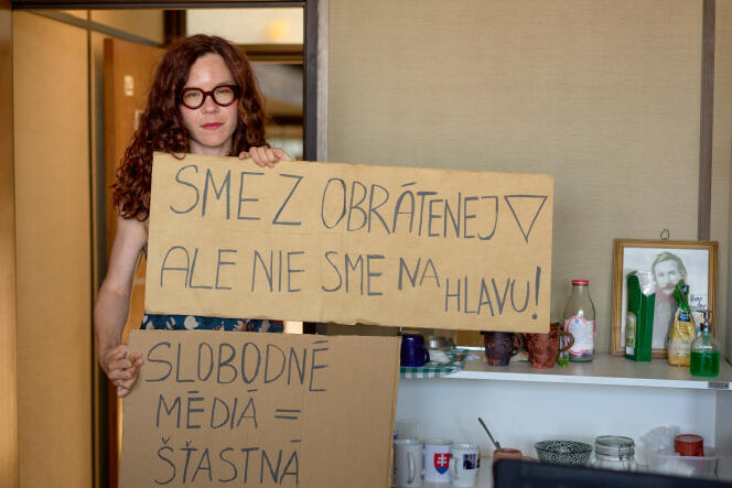 RTVS journalist Kristina Chrenkova with signs reading: 