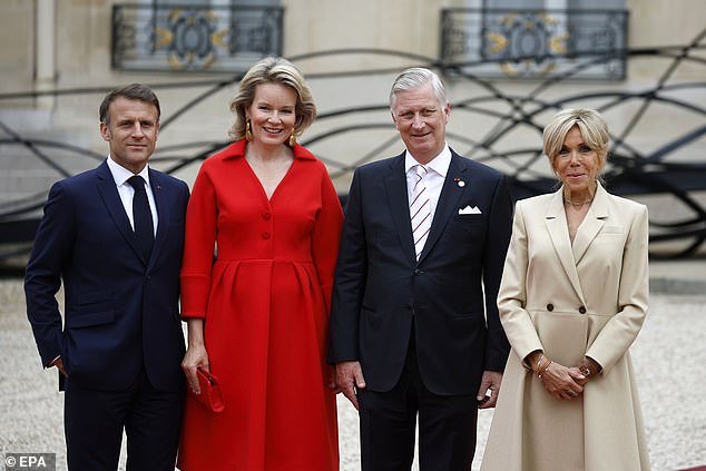 The regal couple was a vision in bold white and red colours, as they arrived alongside King Felipe of Spain , the King and Queen of Denmark, and the Belgian monarchs. Pictured: French President Emmanuel Macron (L) and his wife Brigitte (R) pose for a photo with King Philippe and Queen Mathilde of Belgium