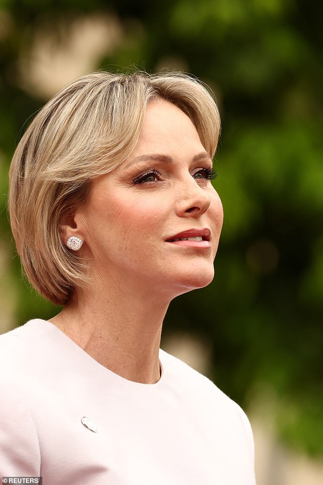 Charlene looked stunning a dusky pink jumpsuit as she arrived at the Elysee Palace in Paris today