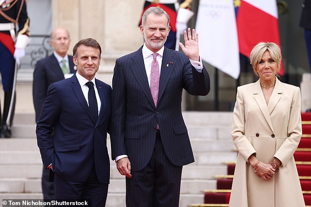 The Spanish King, sporting a pinstriped blazer and colourful tie, waved as he arrived at the Palace