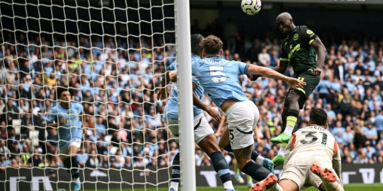 Yoane Wissa (R) heads Brentford into an early lead at Manchester City (Oli SCARFF)