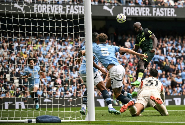 Yoane Wissa (R) heads Brentford into an early lead at Manchester City (Oli SCARFF)