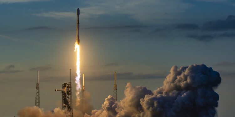 a white and black rocket launches into a darkening sky