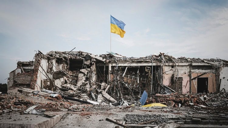 devastation under a Ukraine flag