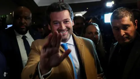 Reuters Far right political party Chega leader Andre Ventura arrives to the headquarters of the party, after the first exit polls were announced