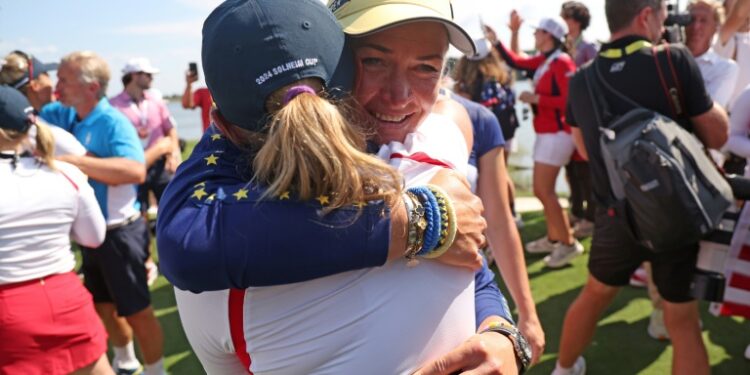 Europe captain Suzann Pettersen, facing front, hugs US captain Stacy Lewis after the Americans beat Europe to win the Solheim Cup (Gregory Shamus)