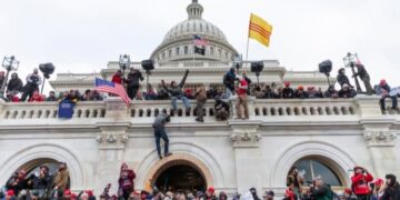 Rioting crowd clambering up Capitol building