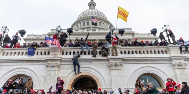 Rioting crowd clambering up Capitol building