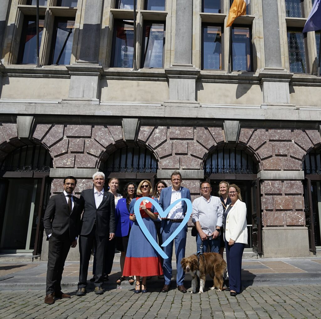 Representatives from NGOs Sürya, PAG-ASA, and Payoke, alongside Belgian Justice Minister, Paul Van Tigchelt and UNODC and IOM representatives,