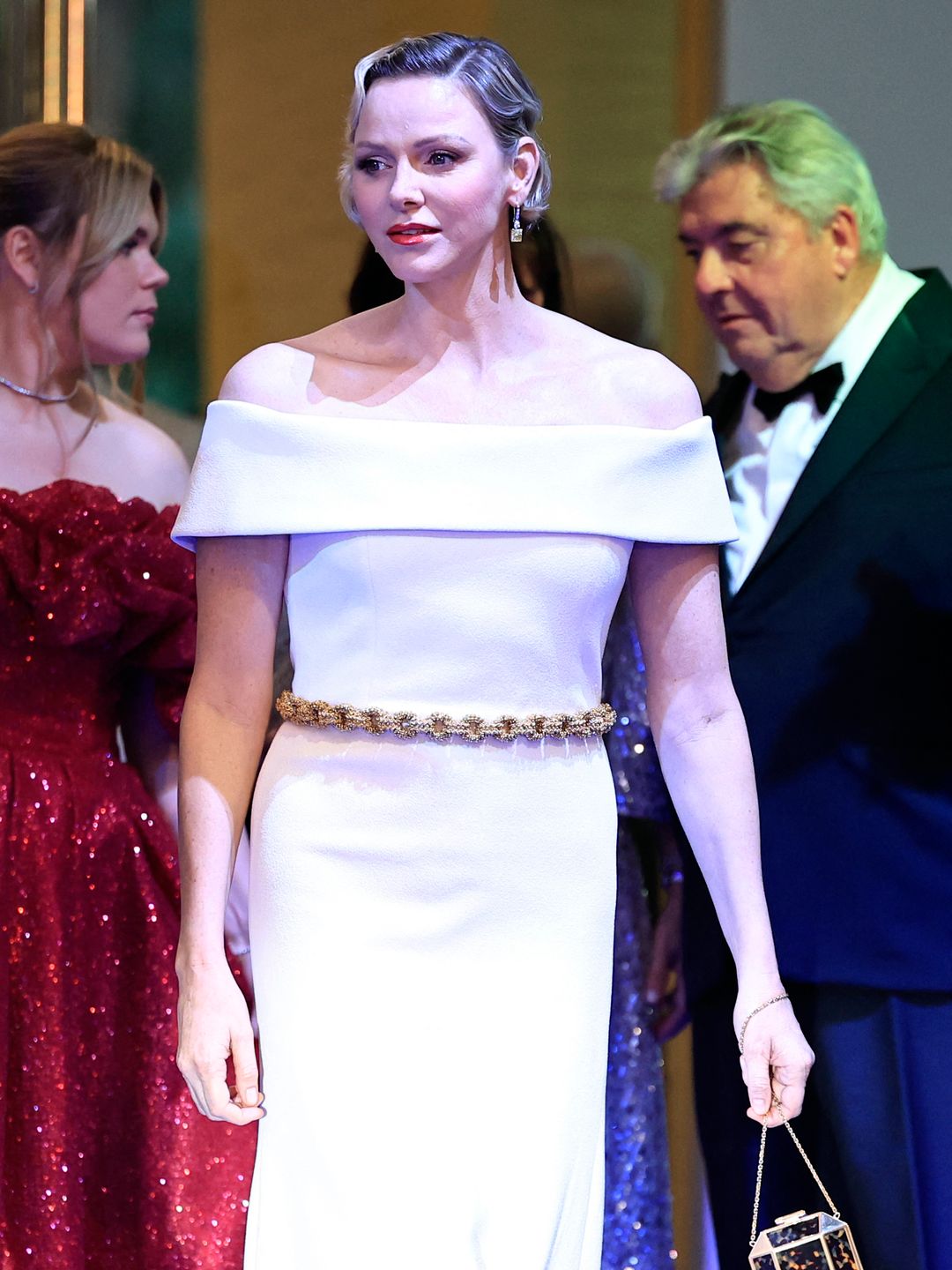 Full-body image of Princess Charlene in a white dress