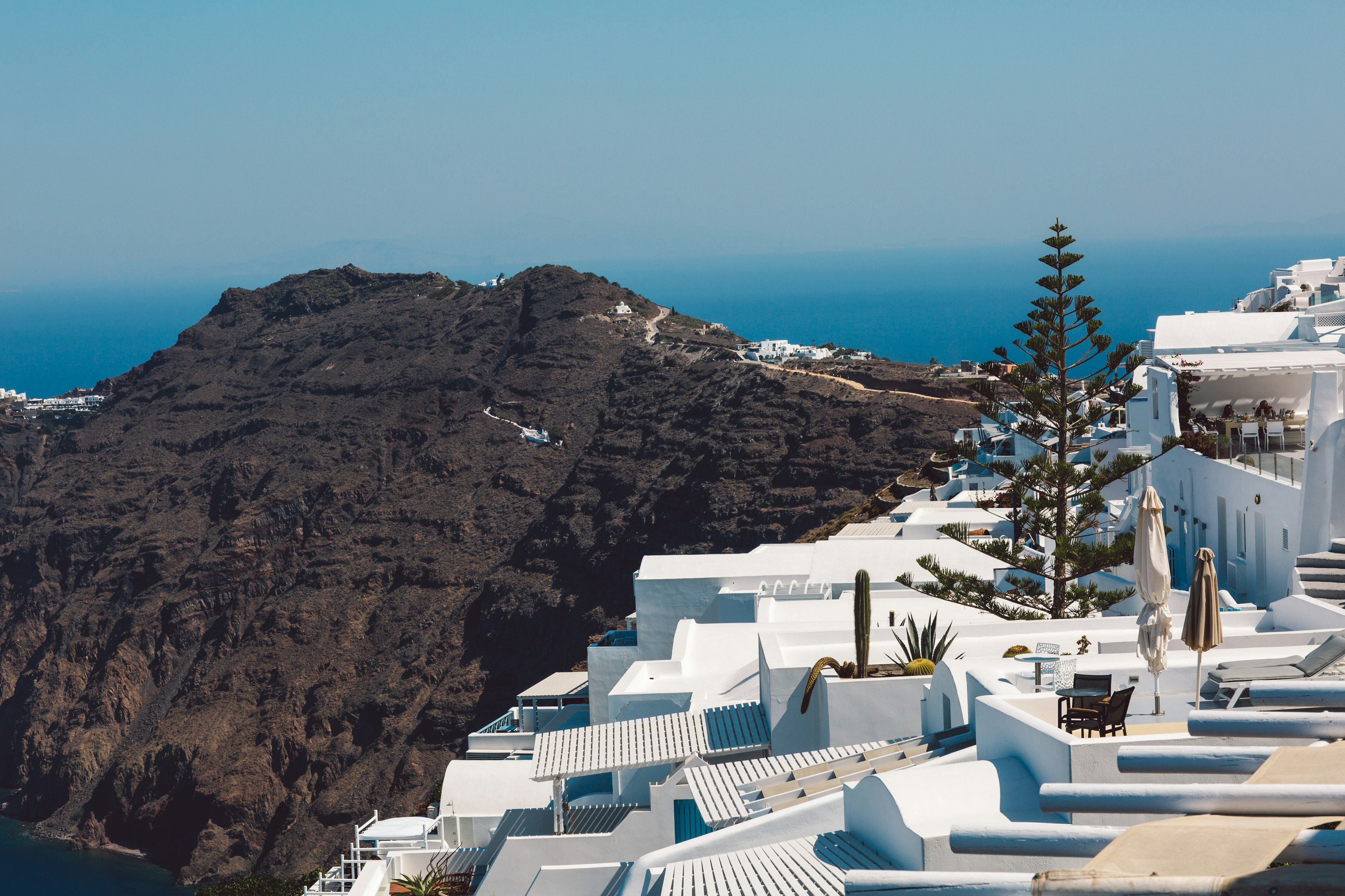 White houses and mountain scenery in the winter months against a blue sky in Merovigli, Santorini Greece