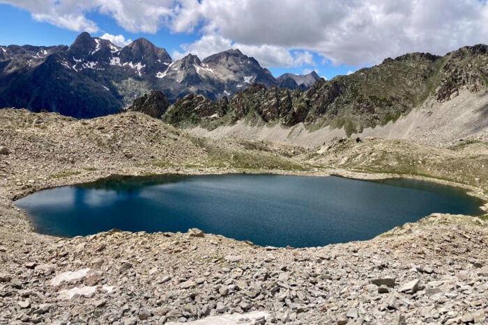 View of mountains and land with a calm circle of water in the middle