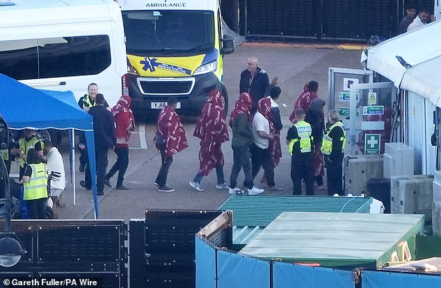 A group of people thought to be migrants are brought in to Dover, Kent, from the RNLI Dover Lifeboat following a small boat incident in the Channel on Saturday