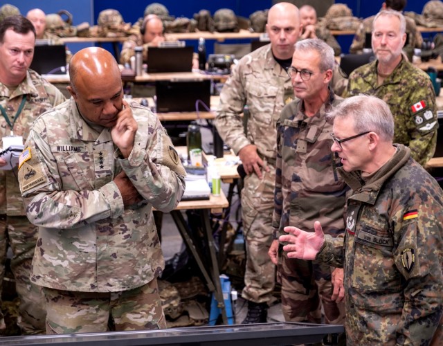 Col. Michael Von Block, the German Senior National Representative assigned to Allied Rapid Reaction Corps, front-right, briefs Gen. Darryl A. Williams, US Army Europe and Africa Commanding General, center, on the concept of current operations and...