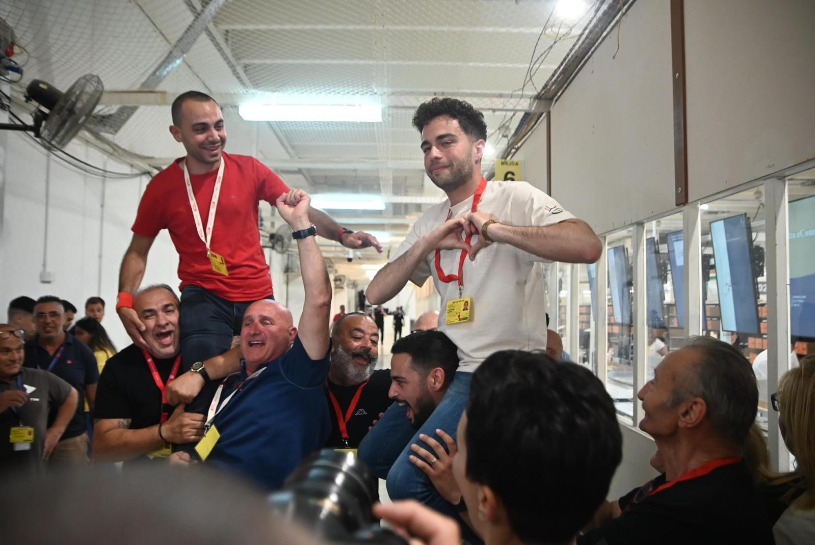 Daniel Attard and Thomas Bajada are carried by PL delegates. Photo: Matthew Mirabelli