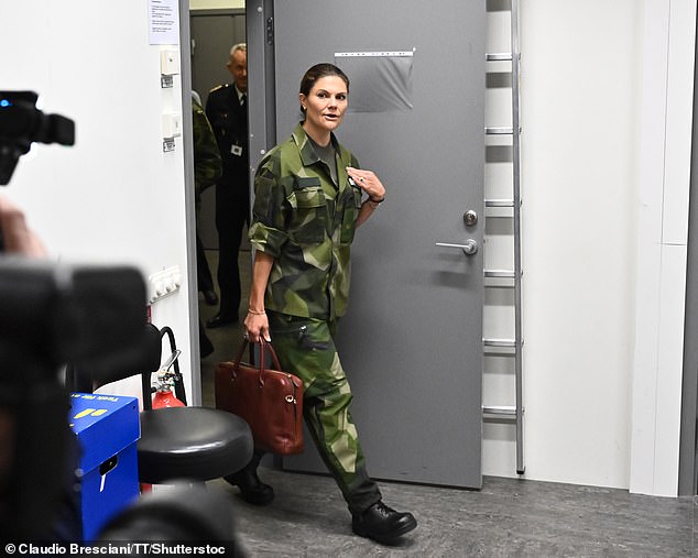 The mother-of-two donned the army's uniform, comprising cargo trousers and a matching shirt with the flag of Switzerland emblazoned on its sleeve