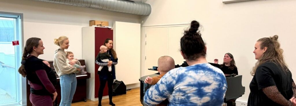 A group of women, some holding small babies