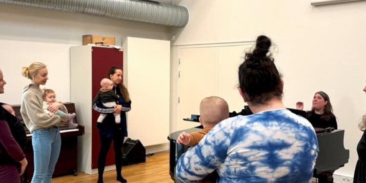 A group of women, some holding small babies