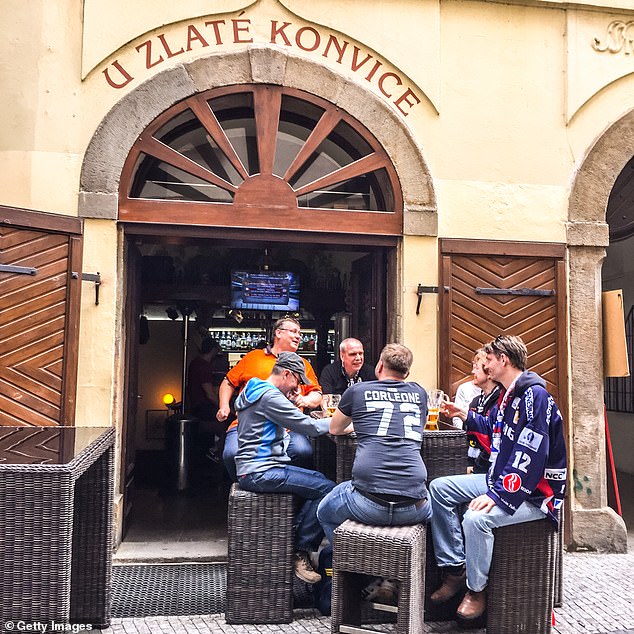 Prague has been inundated with Britons seeking ‘cheap drinks and women’ ever since the Czech Republic joined the European Union over two decades ago (pictured: People drinking beer in Prague cafe)