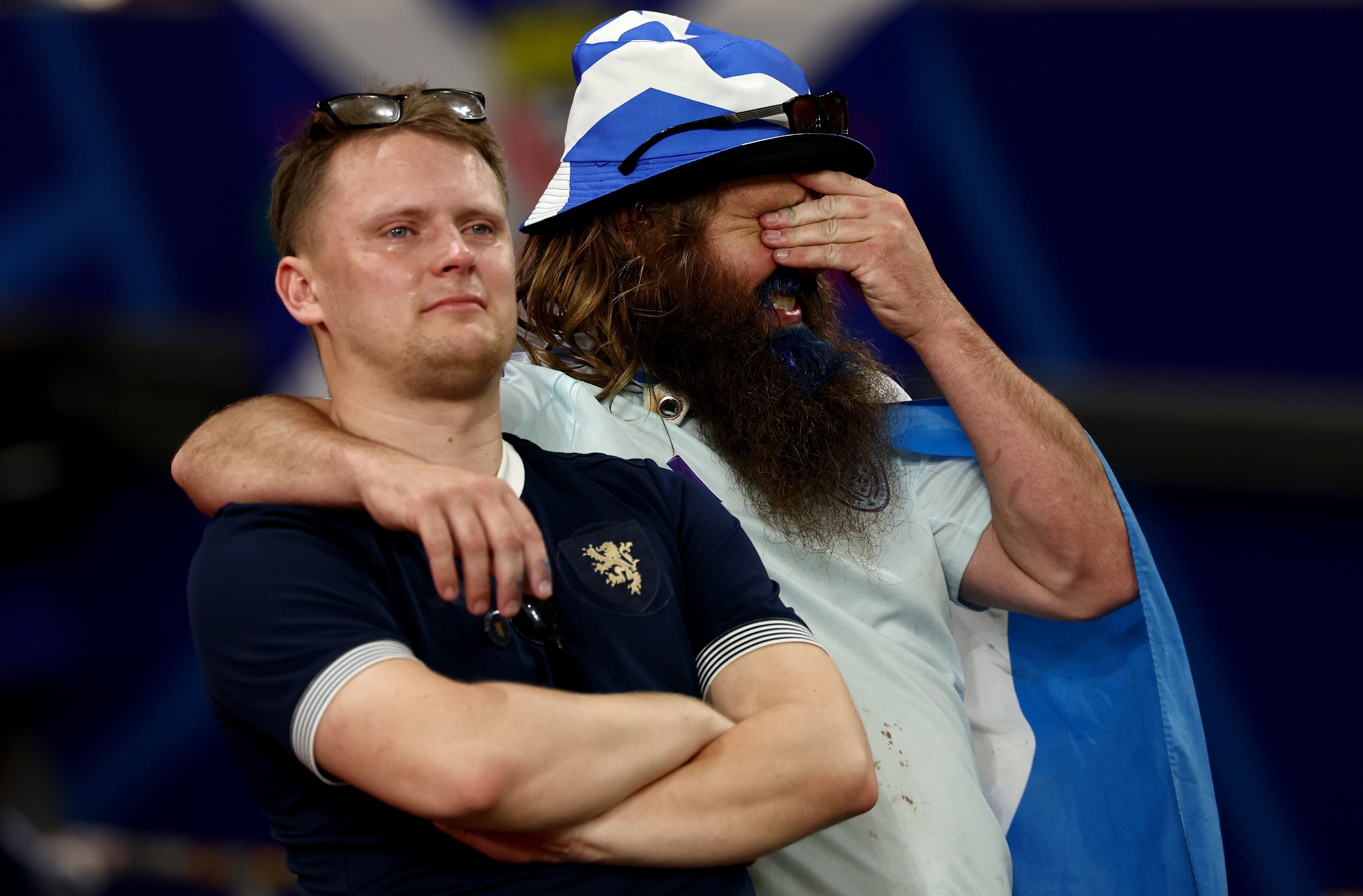 Dejected fans of Scotland after their Euro 2024 exit