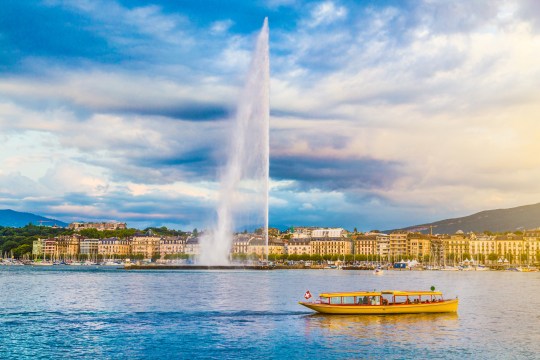 City of Geneva with Jet d'Eau fountain at sunset, Switzerland