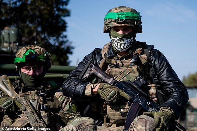 Ukrainian soldiers from the Liut Brigade sit in a pickup truck on their way back to the frontline town near Chasiv Yar in Donetsk Region, Ukraine on October 07, 2024