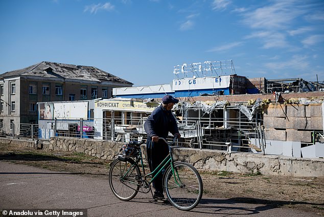 A local resident walks next to destroyed buildings following Russian air attack in Druzhkivka in Donetsk Region