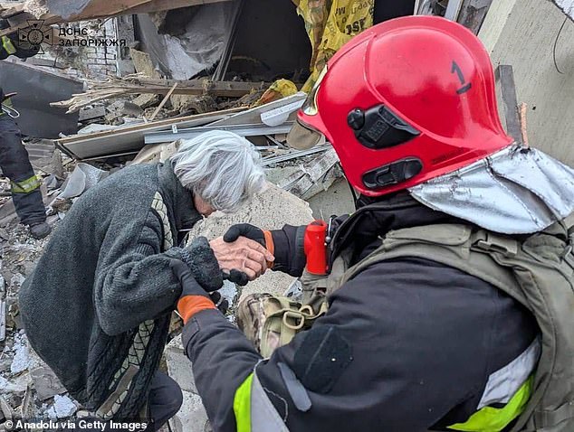 Search and rescue members conduct operation as they rescue residents from damaged houses in Zaporizhzhia