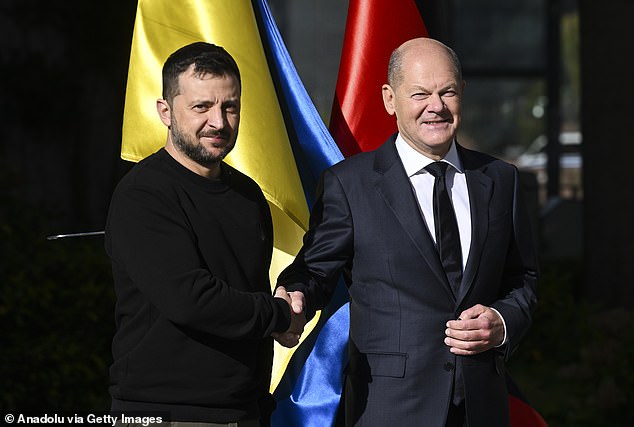 German Chancellor Olaf Scholz (R) shakes hands with Ukrainian President Volodymyr Zelensky