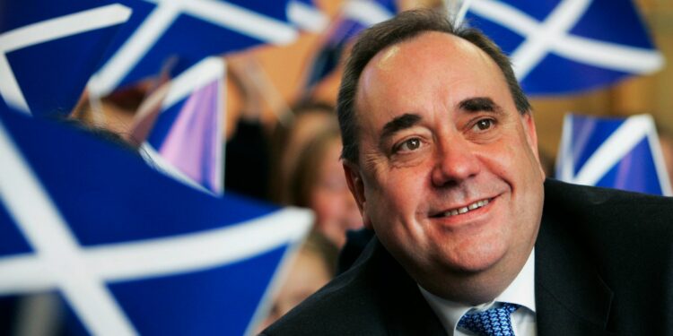 Scotland's then first minister Alex Salmond smiles surrounded by national flags in 2007. Pic: Reuters