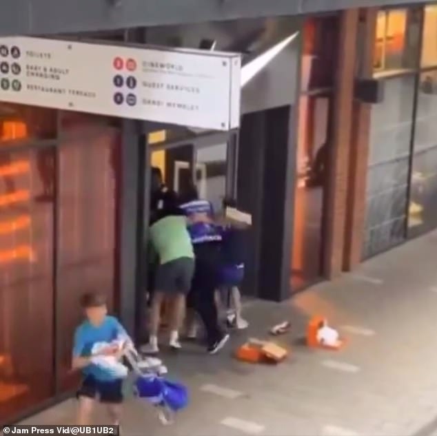 Phone footage from last month shows young shoplifters battling past staff to steal trainers from a Nike shop in the shadows of Wembley Stadium