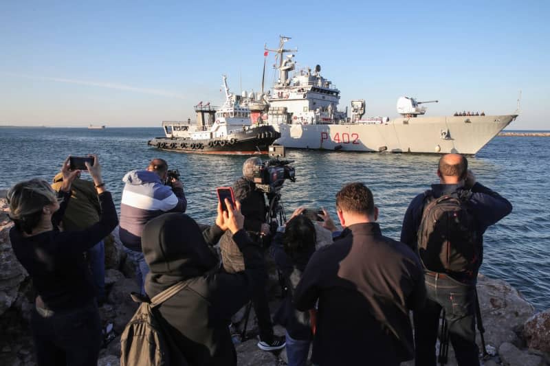 The Italian navy ship Libra, carrying the first migrants whose asylum applications will be processed in Albania instead of Italy, arrives at the port of Shengjin. An Italian navy ship docked in Albania on Wednesday morning, carrying the first group of migrants whose asylum requests are to be processed at new reception centres outside the European Union. Armando Babani/ZUMA Press Wire/dpa